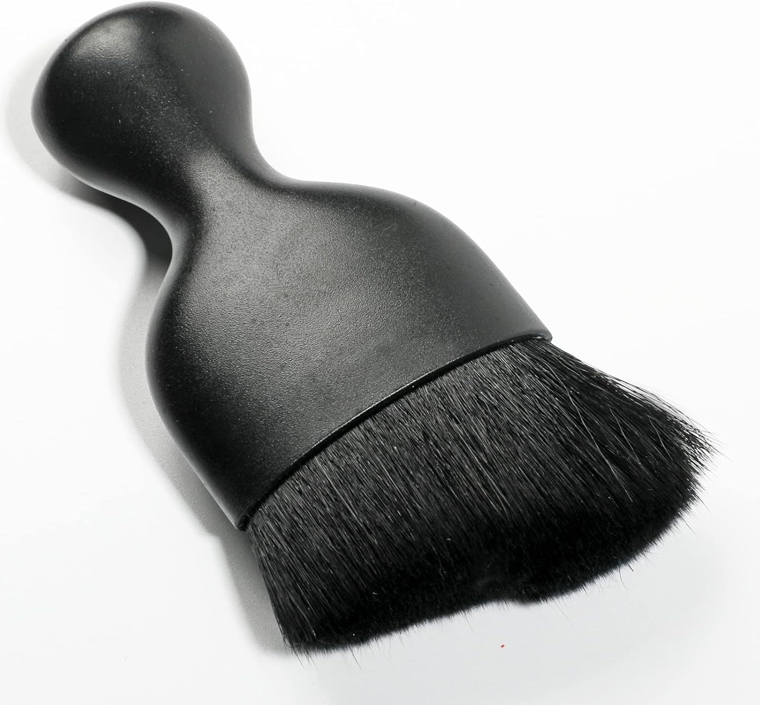 Black car interior detailing brush close-up view