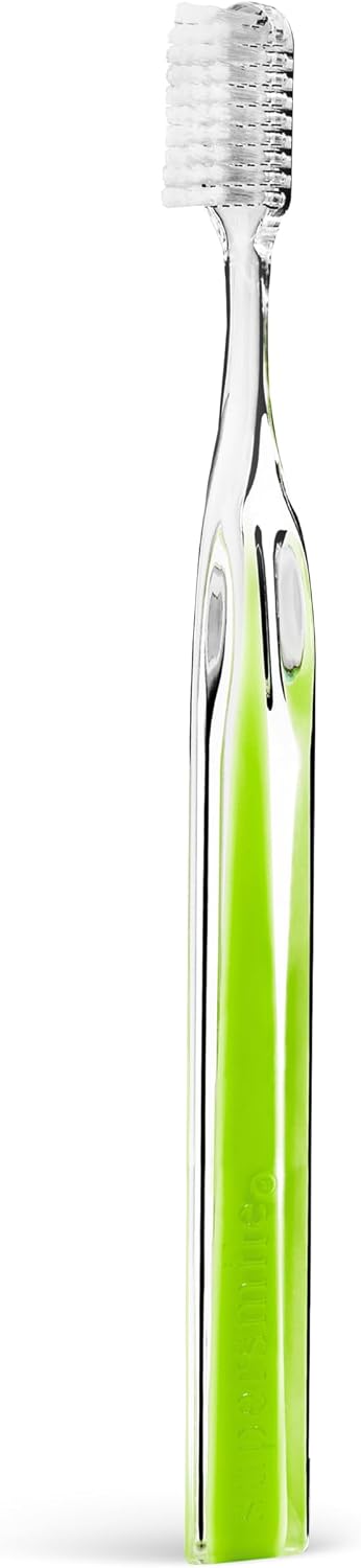 Single soft-bristle manual toothbrush with a transparent-style handle and vibrant green Peridot accent.