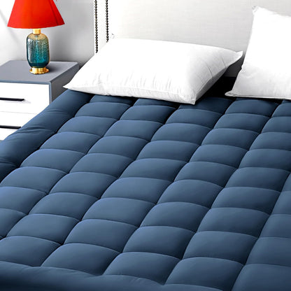 Navy blue breathable cotton mattress pad on queen-size bed