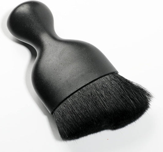 Black car interior detailing brush close-up view
