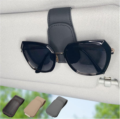 Sunglasses clipped in magnetic car visor holder