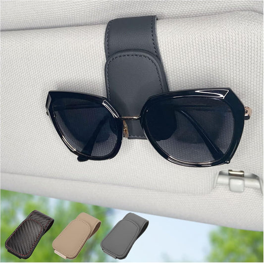 Sunglasses clipped in magnetic car visor holder
