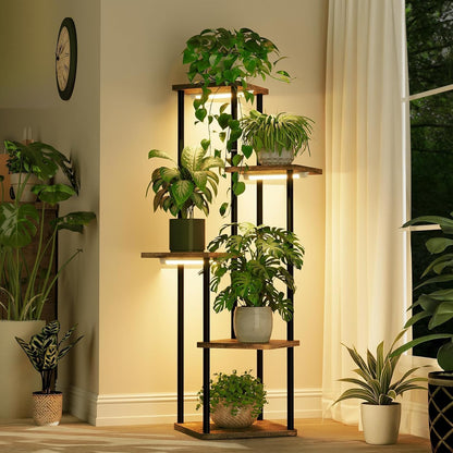 Five-tier corner plant stand with integrated grow lights, black metal frame, wood-look shelves, and potted indoor plants in a modern living room.