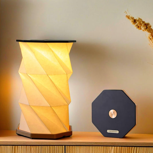 Foldable rechargeable travel lamp glowing with warm light