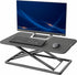 Black tabletop workstation riser with height adjustment