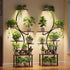 Two S-shaped indoor plant stands with integrated grow lights, wood-look shelves, and multiple potted green plants in a modern living room.