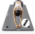 Grey extra-wide textured yoga mat with two hanging holes, shown beneath a woman stretching, with dimension labels and a storage bag inset.